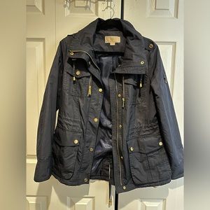 Navy blue Michael Kors raincoat with gold zippers and buttons